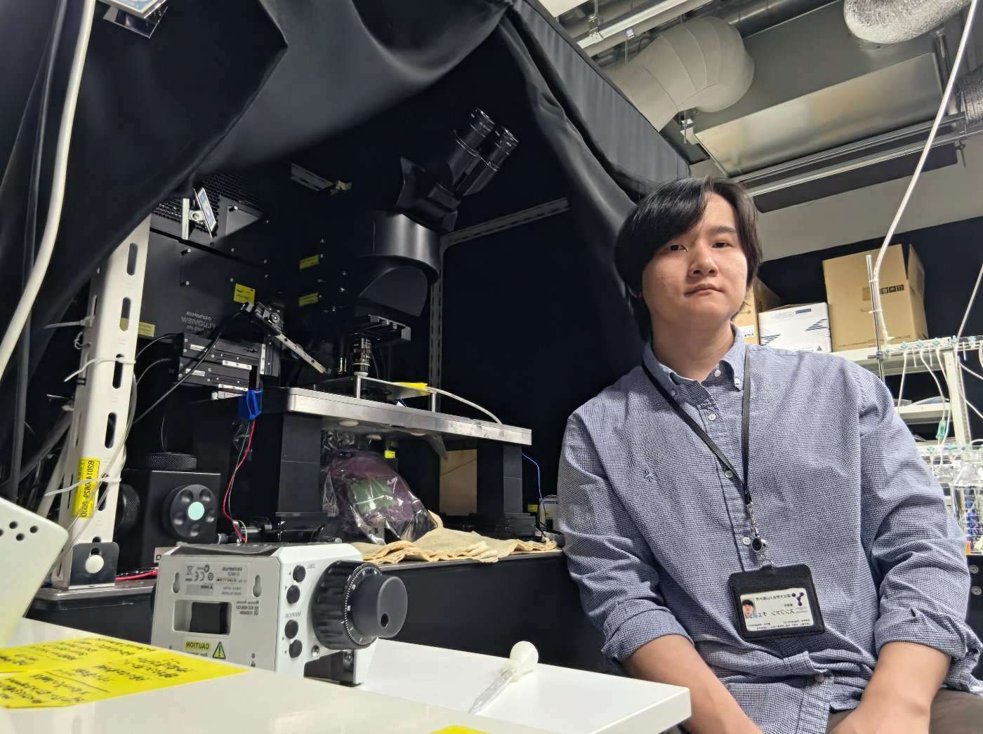 At the two-photon microscope in the laboratory, University of Yamanashi